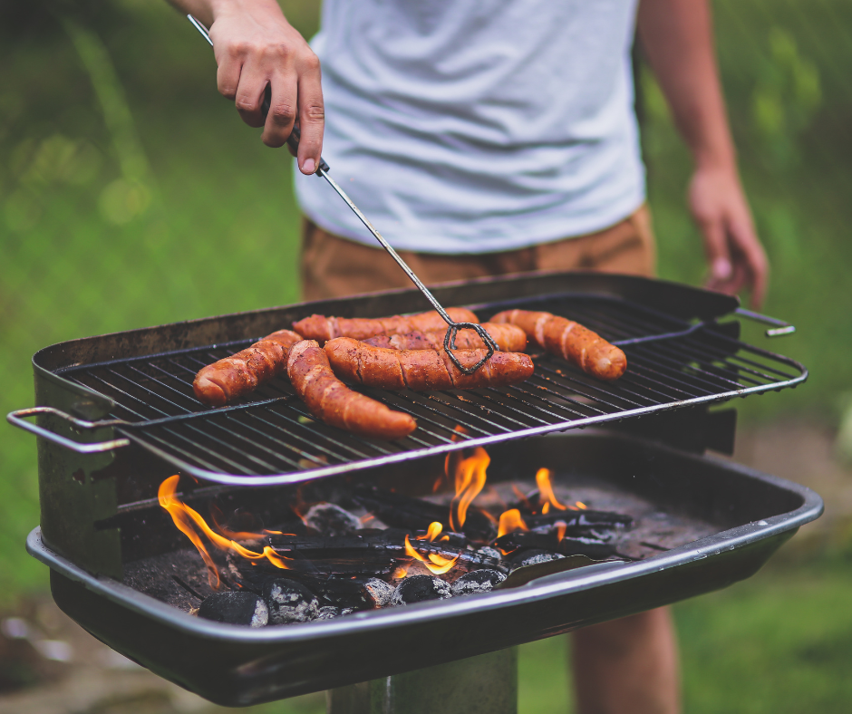 man cooking food on grill